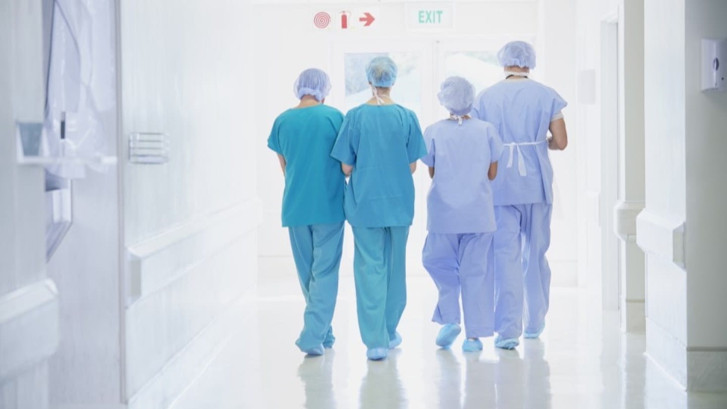 Surgeons walking down a hospital corridor