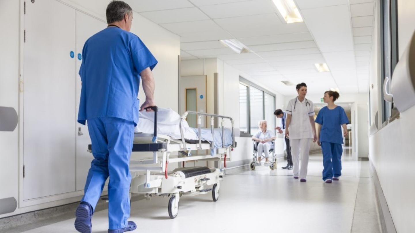 Healthcare worker interacting with patient in wheelchair