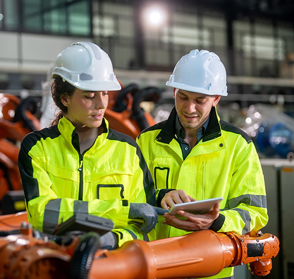 Man and woman with yellow jackets and helmets