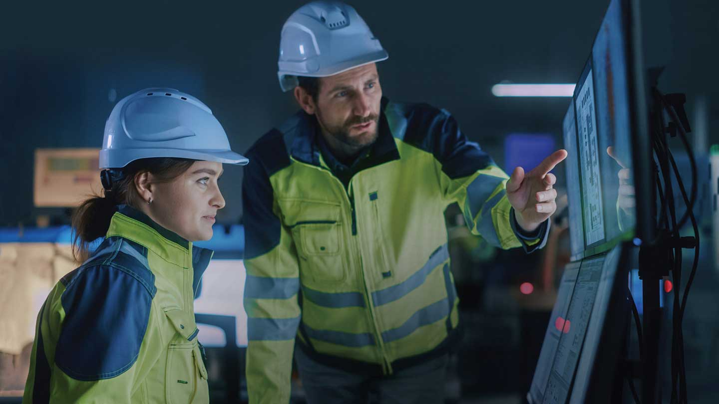 Engineers looking at screen