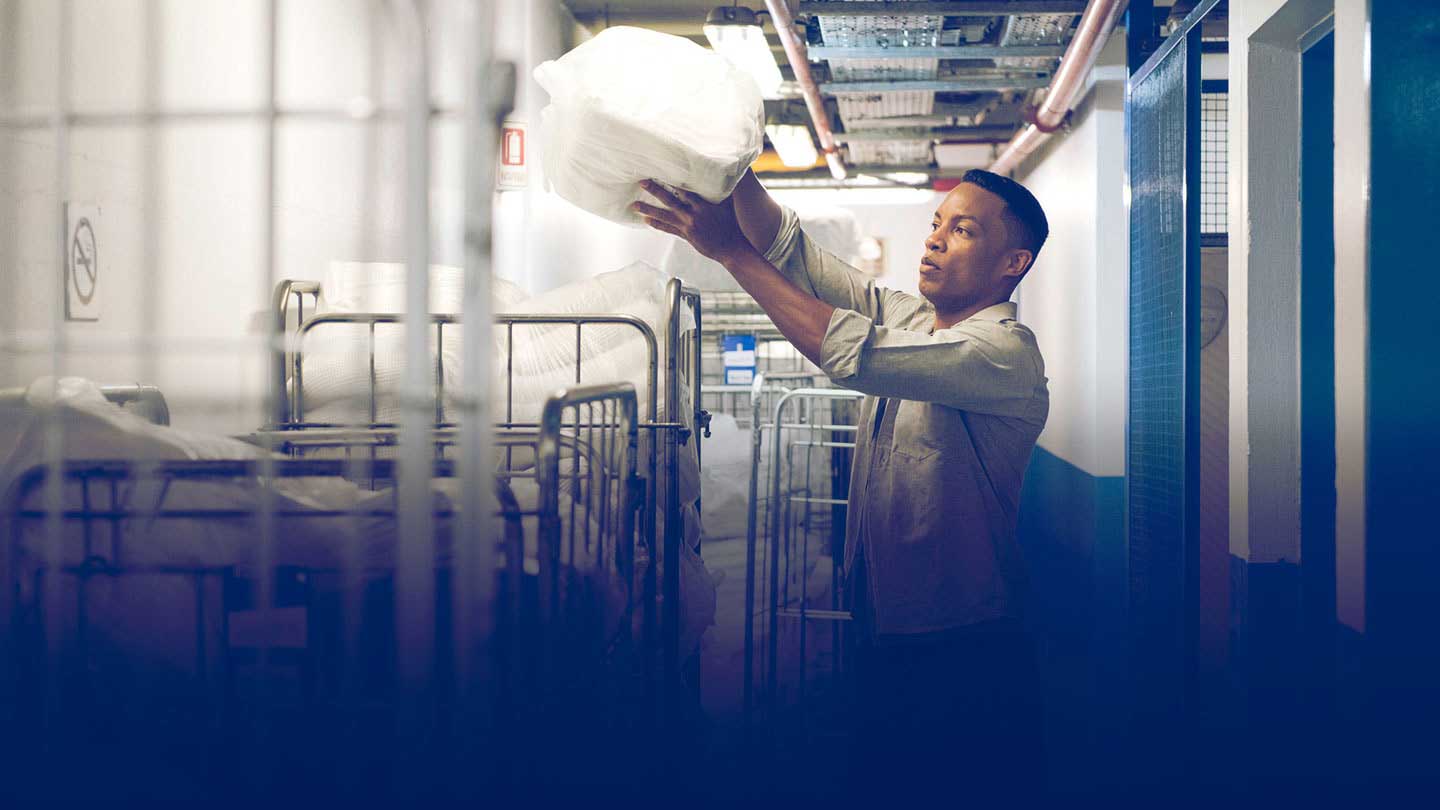 Worker handling laundry