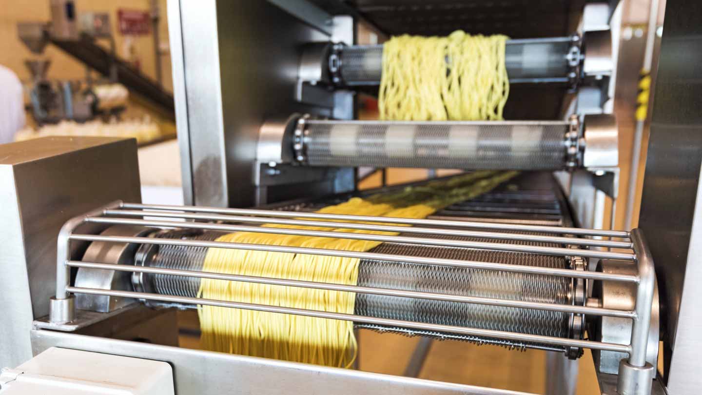 Pasta being processed in a food factory
