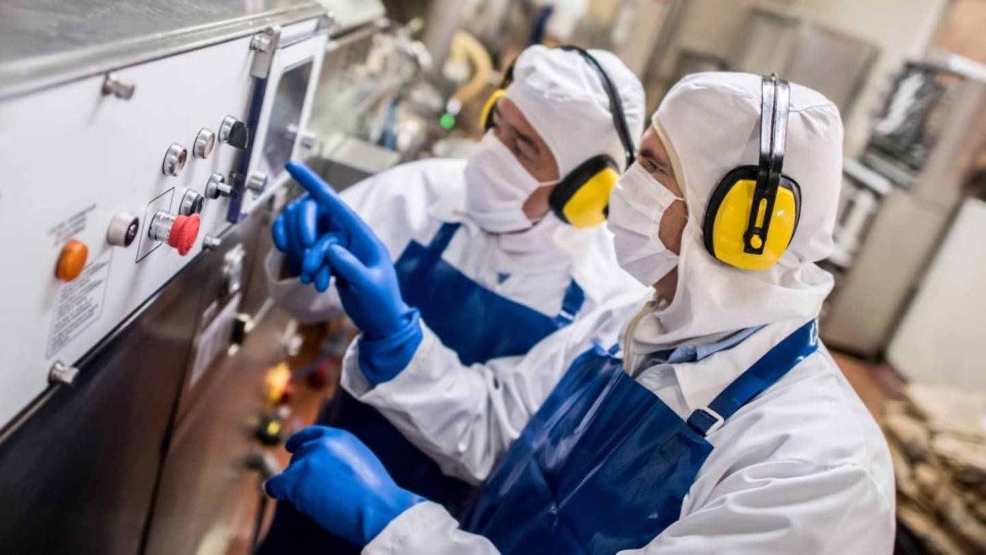 Engineers working in steam plant wearing full PPE