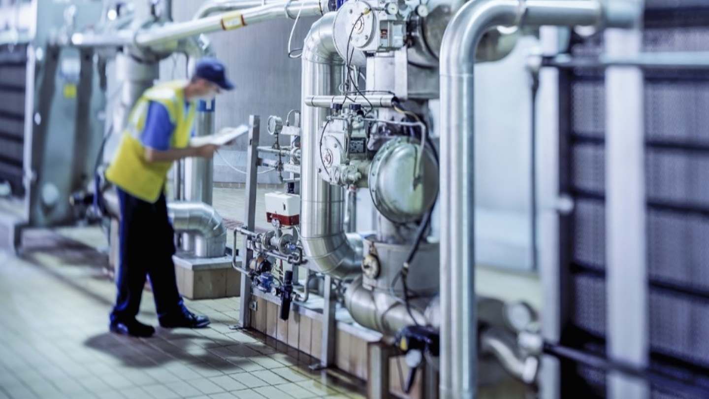 Engineer inspecting brewery equipment