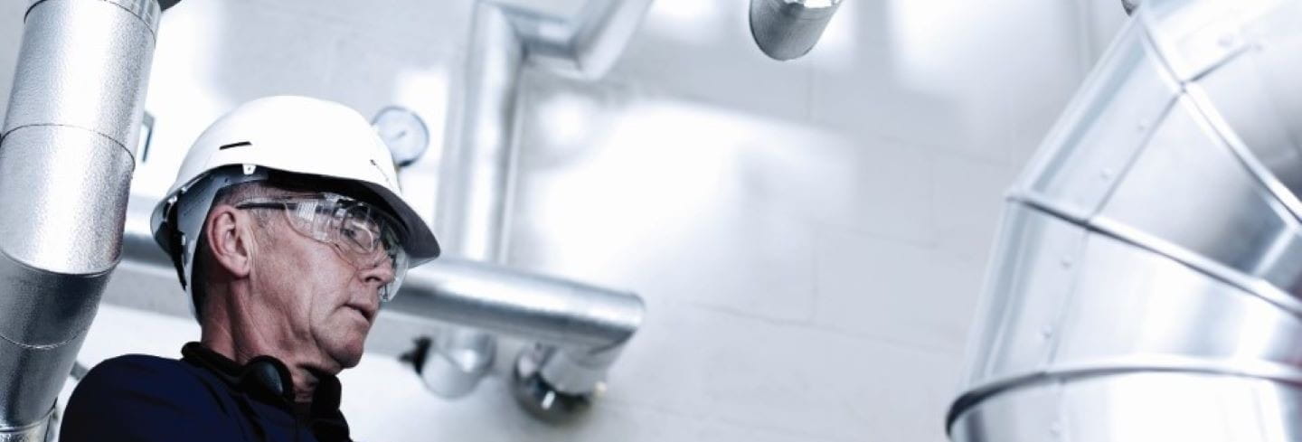 Engineer with clipboard performing checks