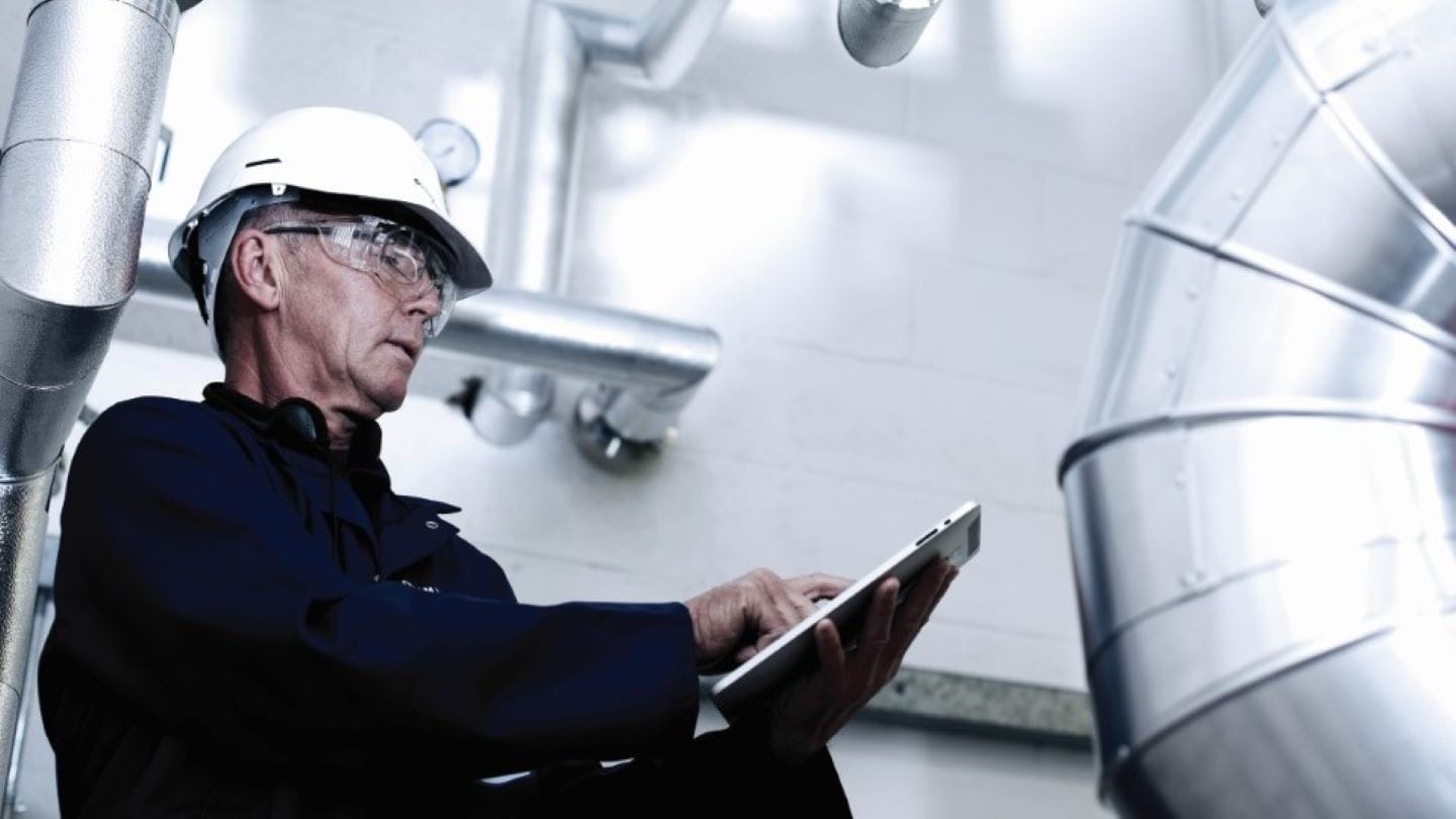 Engineer with clipboard performing checks