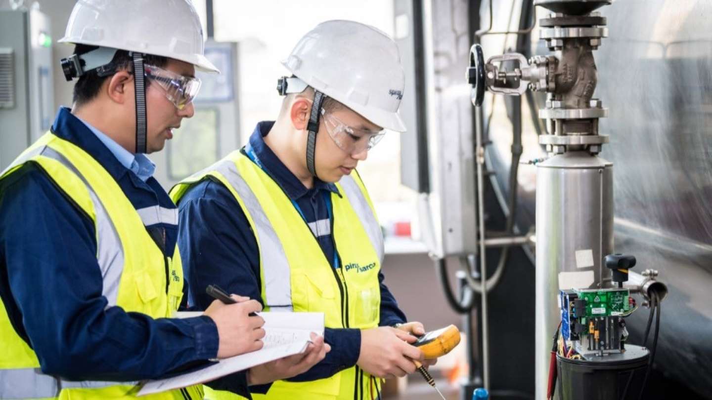 Engineers looking at large project drawing