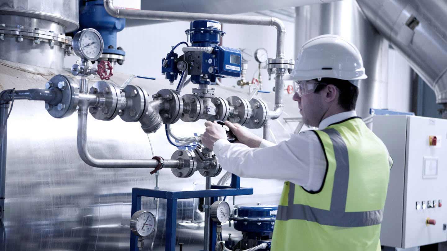 Engineer is checking equipment in steam system